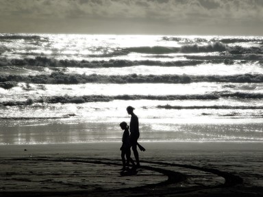 Matt Kent; Company Beach; A mother and daugter at sunset at piha